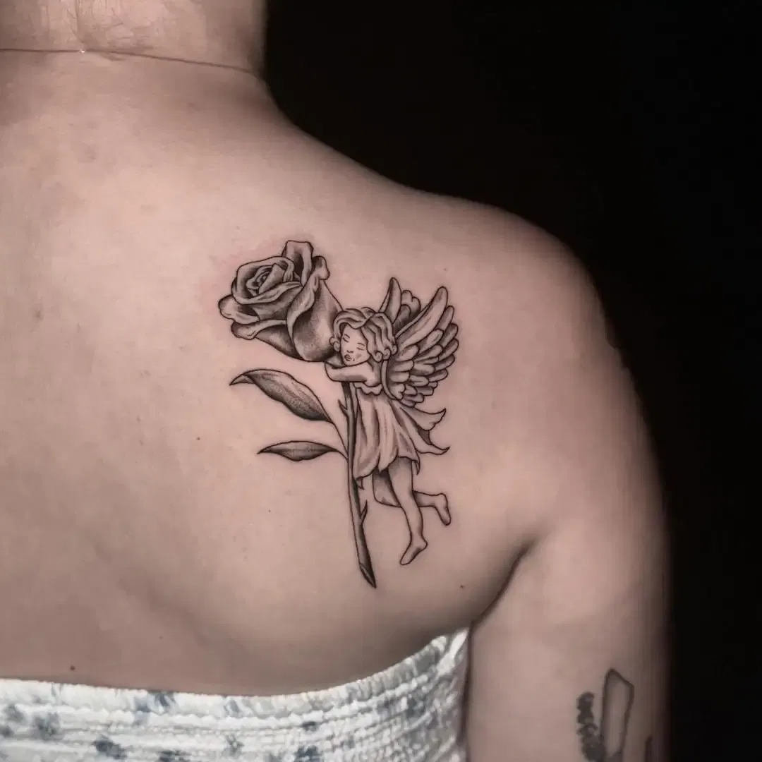 Angel Holding Flower Tattoo